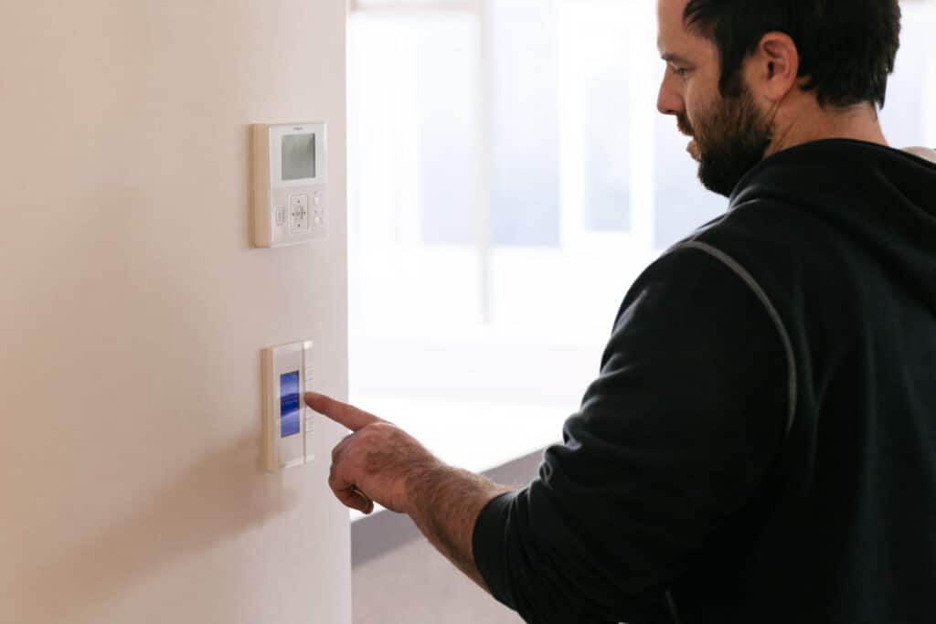 man using control panel on wall