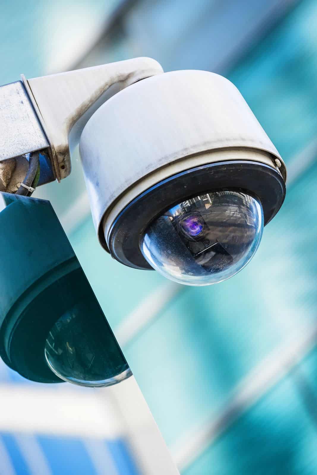 security cameras against teal background